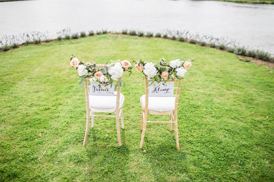 Bride and groom chairs with florals